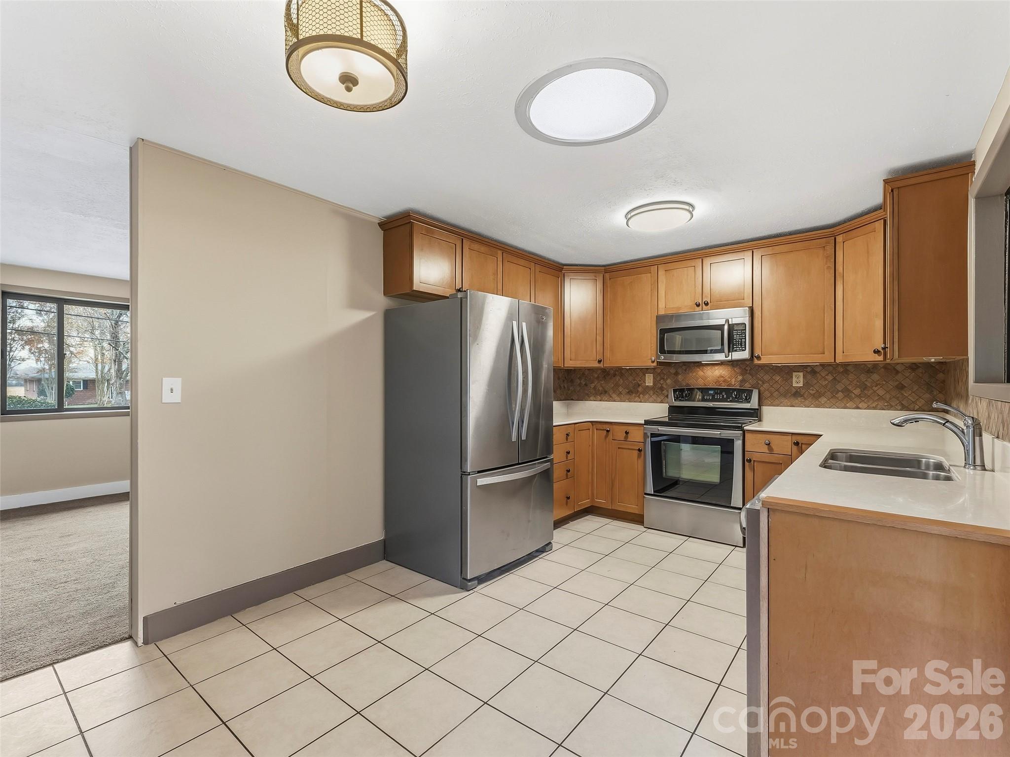 605 Dana Road Hendersonville, NC 28792 - Photo 16 of 38 a kitchen with a refrigerator a stove top oven and sink