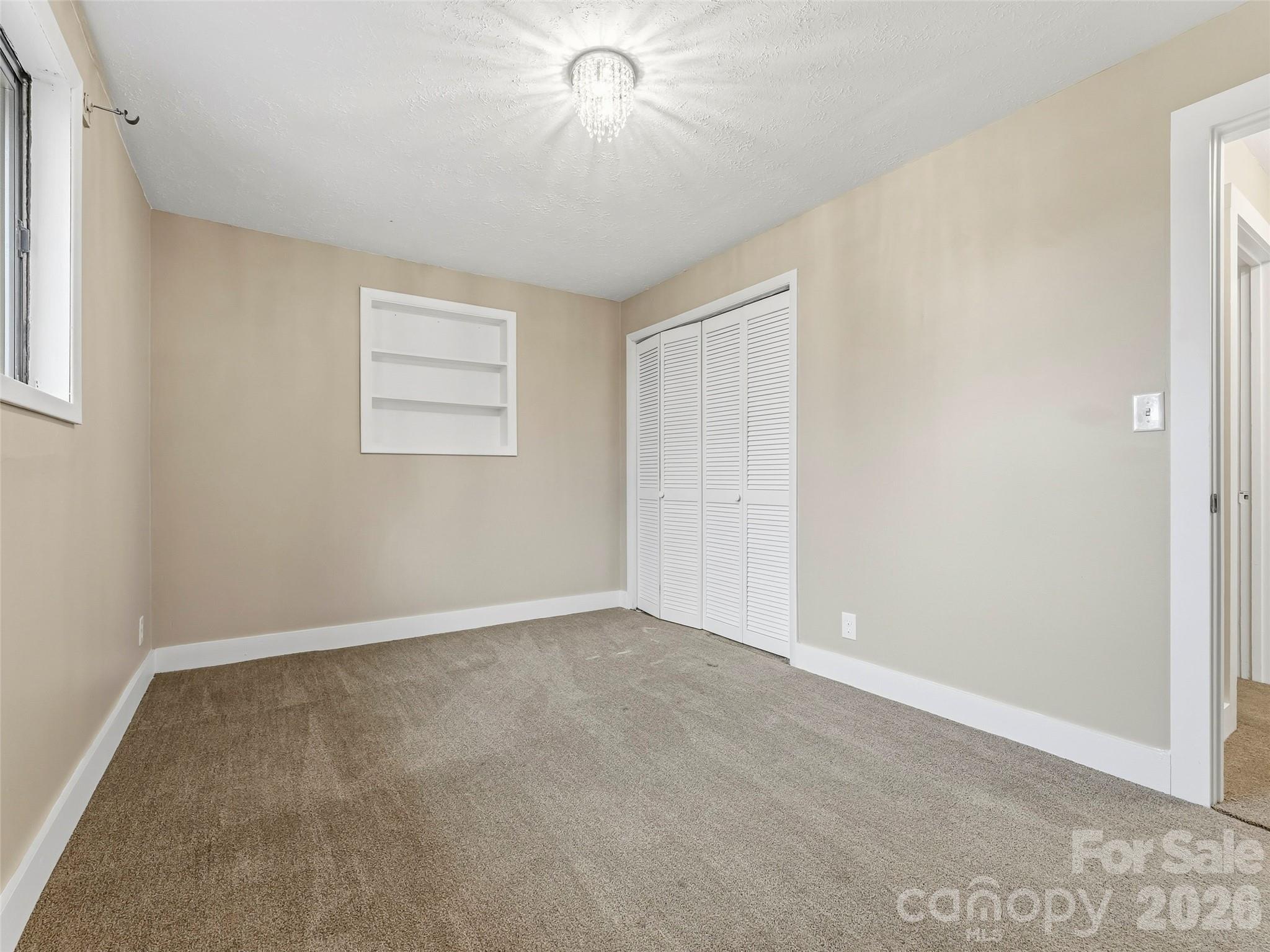 605 Dana Road Hendersonville, NC 28792 - Photo 22 of 38 an empty room with windows and fan