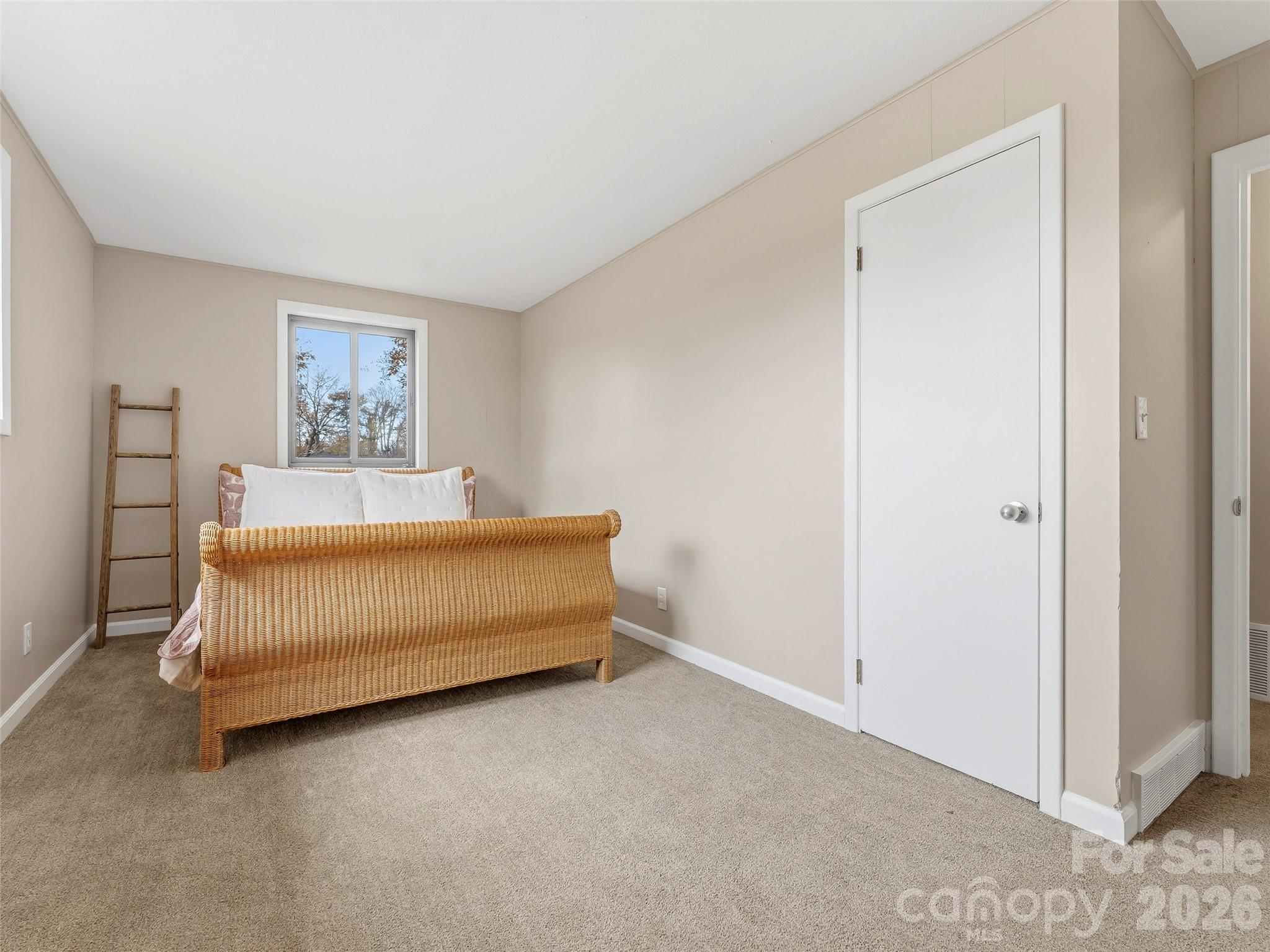 605 Dana Road Hendersonville, NC 28792 - Photo 30 of 38 a bedroom with a bed and a window