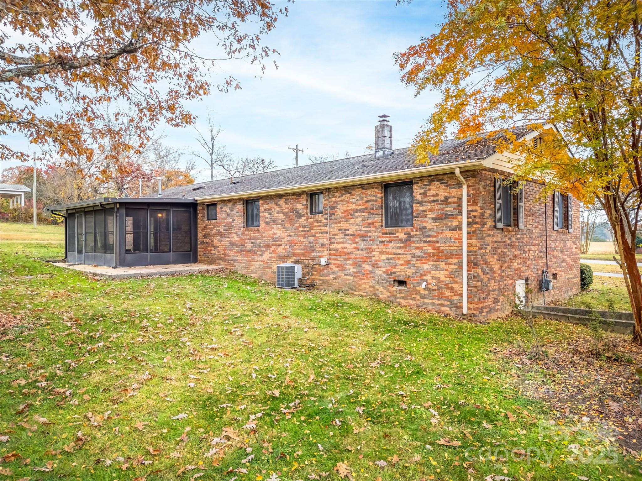 605 Dana Road Hendersonville, NC 28792 - Photo 8 of 38 a brick house with a large tree in front of it