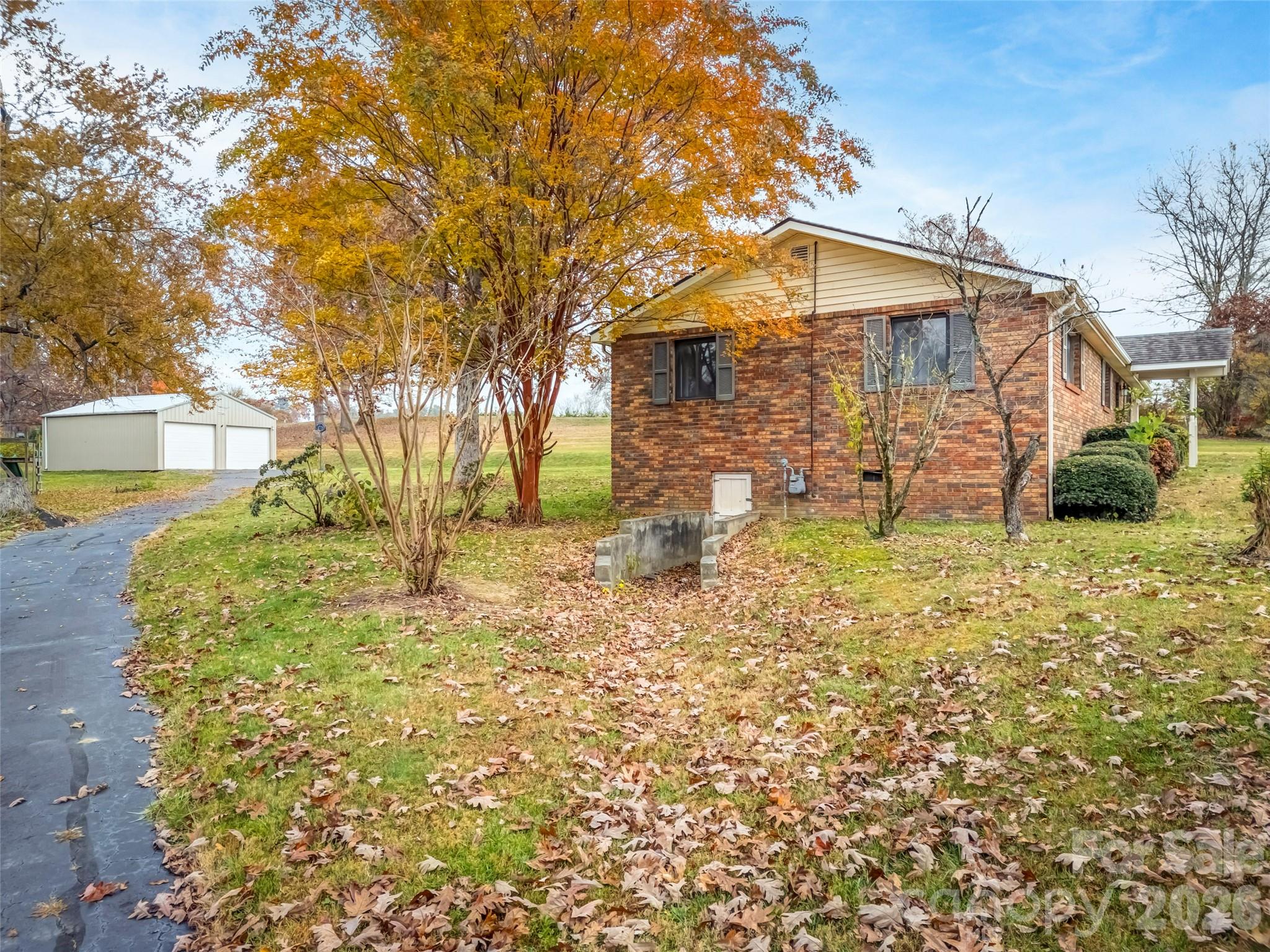 605 Dana Road Hendersonville, NC 28792 - Photo 10 of 38 a view of a yard with plants and brick wall