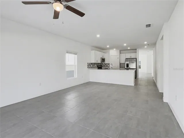 a view of a kitchen with a sink and stainless steel appliances