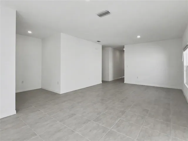 a kitchen with white cabinets and appliances