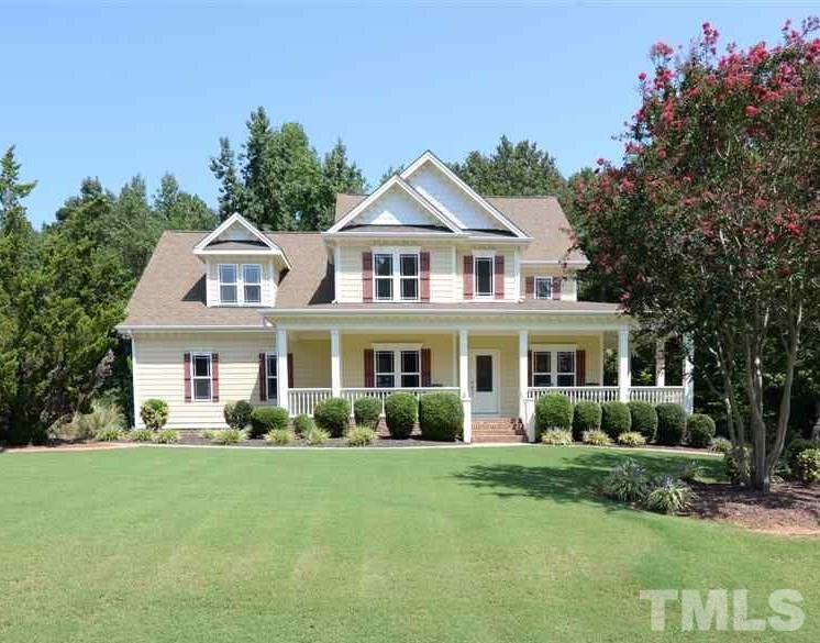1021 Grissom Farm Road Garner, NC 27529 - Photo 1 of 25 a front view of a house with a garden