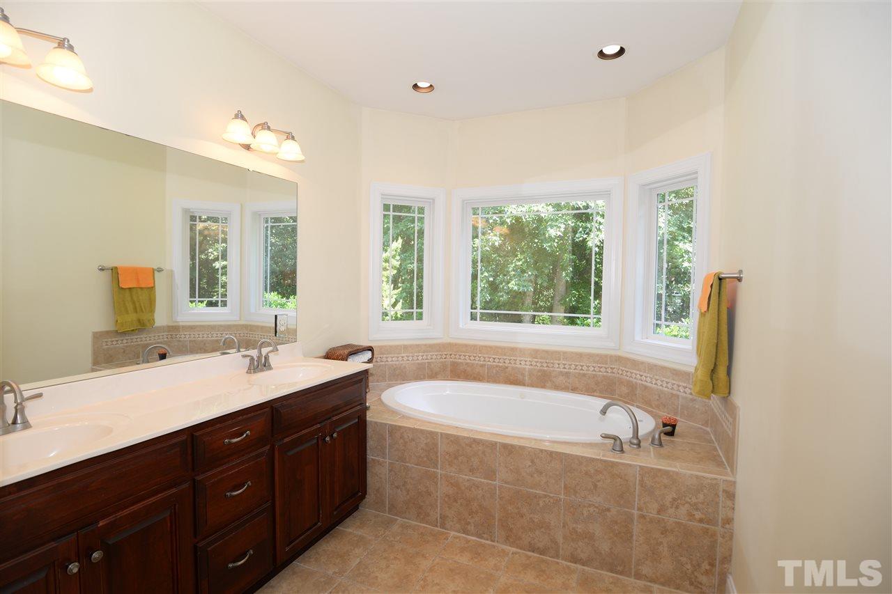 1021 Grissom Farm Road Garner, NC 27529 - Photo 13 of 25 a bathroom with a granite countertop tub sink and mirror