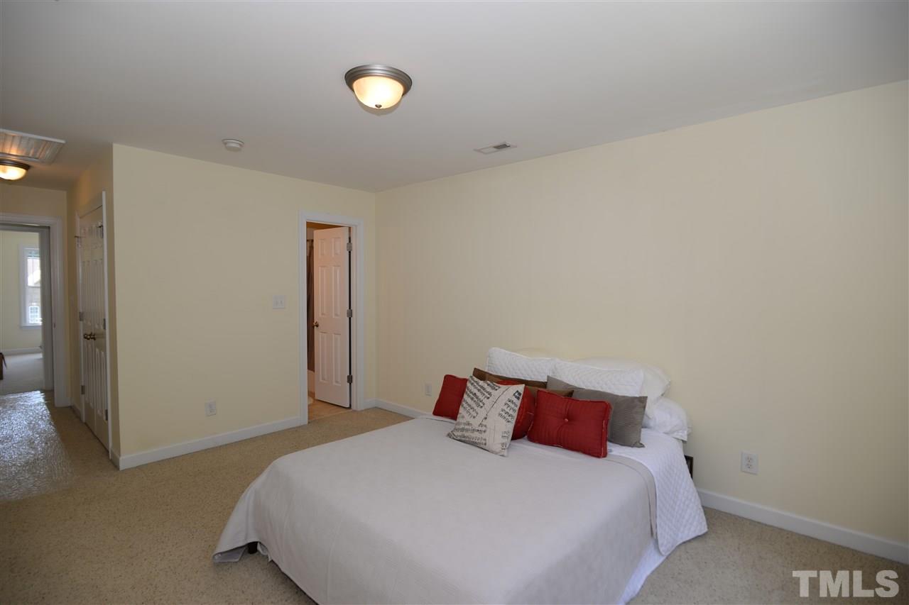 1021 Grissom Farm Road Garner, NC 27529 - Photo 14 of 25 a bedroom with a bed and a night stand