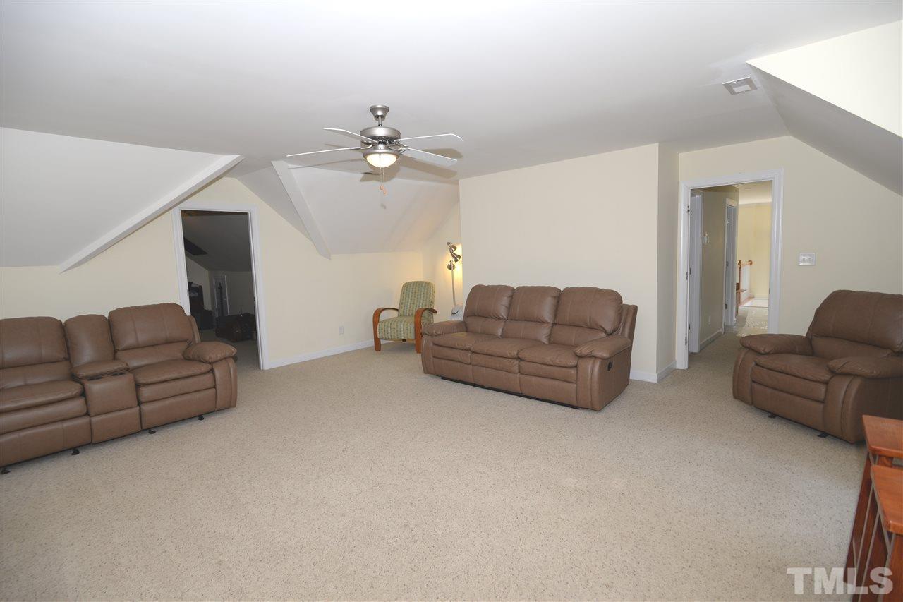 1021 Grissom Farm Road Garner, NC 27529 - Photo 17 of 25 a living room with furniture and a chandelier