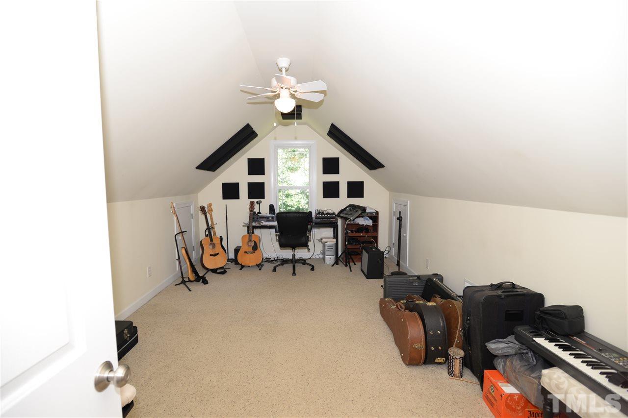 1021 Grissom Farm Road Garner, NC 27529 - Photo 18 of 25 a view of a workspace with furniture and a ceiling fan