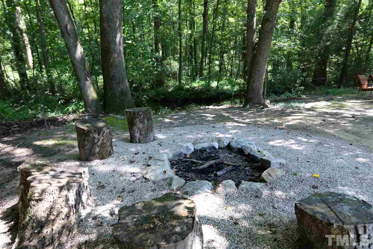 1021 Grissom Farm Road Garner, NC 27529 - Photo 22 of 25 a backyard of a house with lots of green space