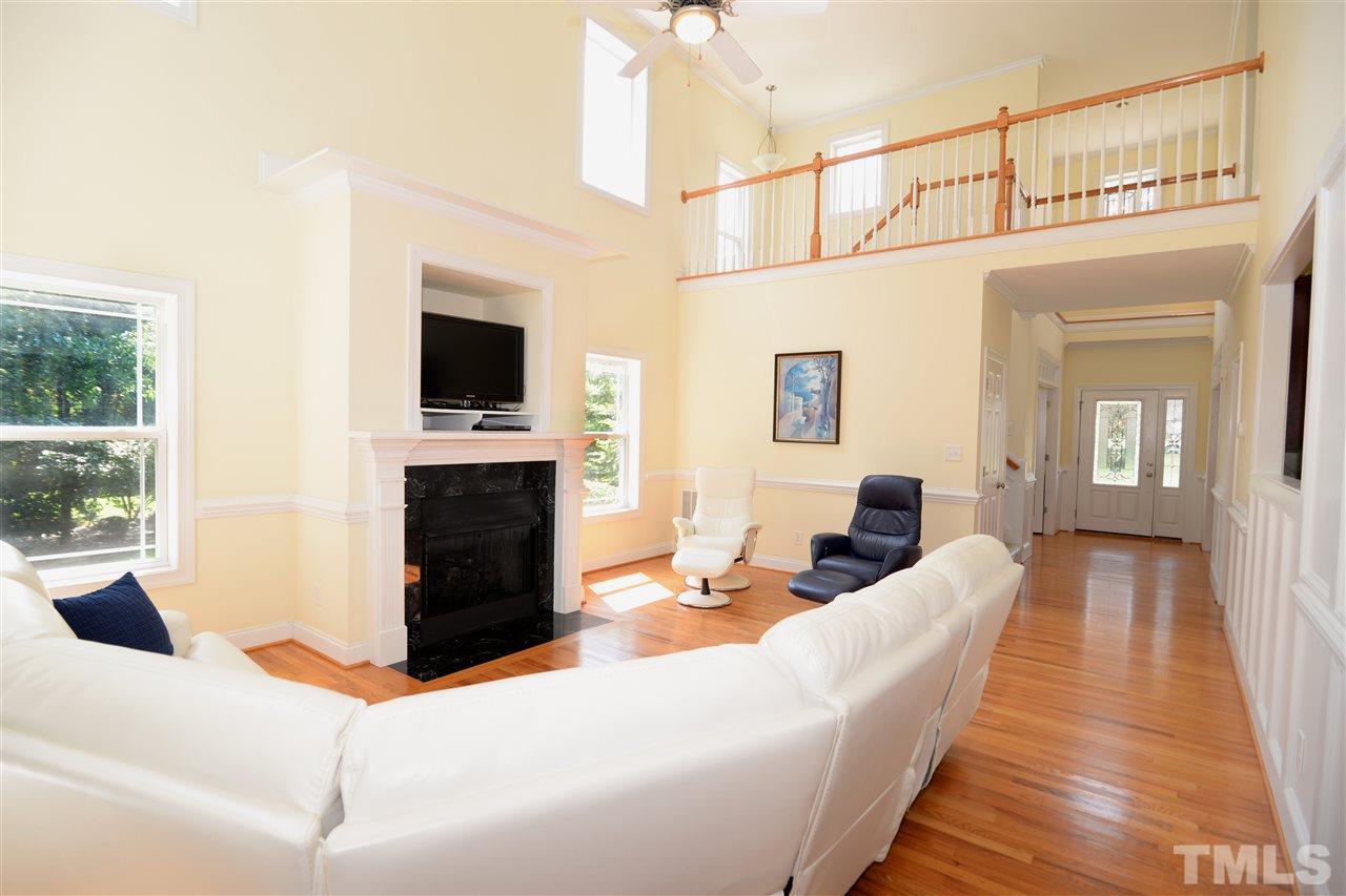 1021 Grissom Farm Road Garner, NC 27529 - Photo 7 of 25 a living room with furniture a flat screen tv and a fireplace
