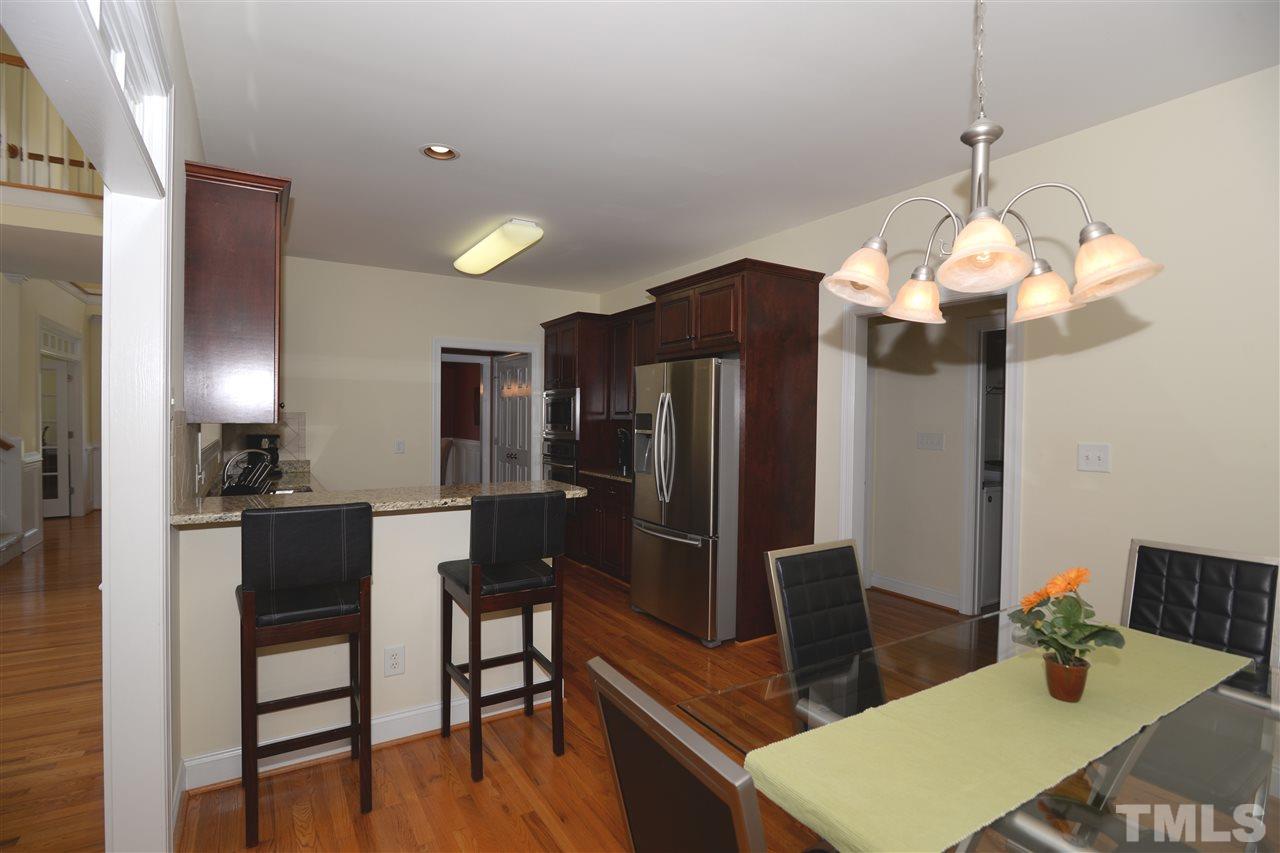 1021 Grissom Farm Road Garner, NC 27529 - Photo 9 of 25 a view of a dining room with furniture and wooden floor