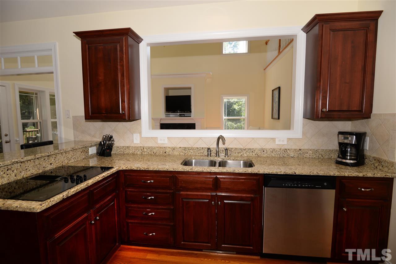 1021 Grissom Farm Road Garner, NC 27529 - Photo 10 of 25 a kitchen with granite countertop a sink cabinets and stainless steel appliances