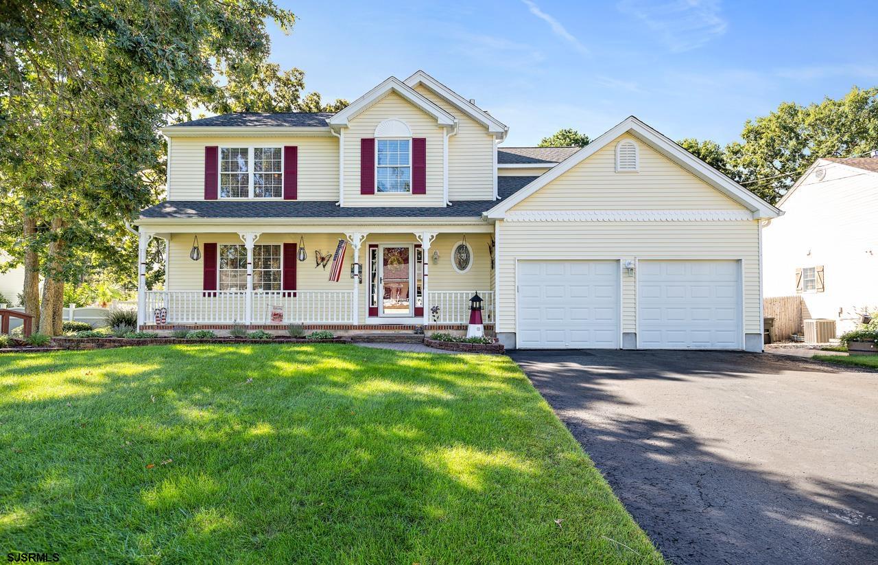 203 Torpedo Road Manahawkin, NJ 08050 - Photo 1 of 48 a front view of a house with a yard and garage