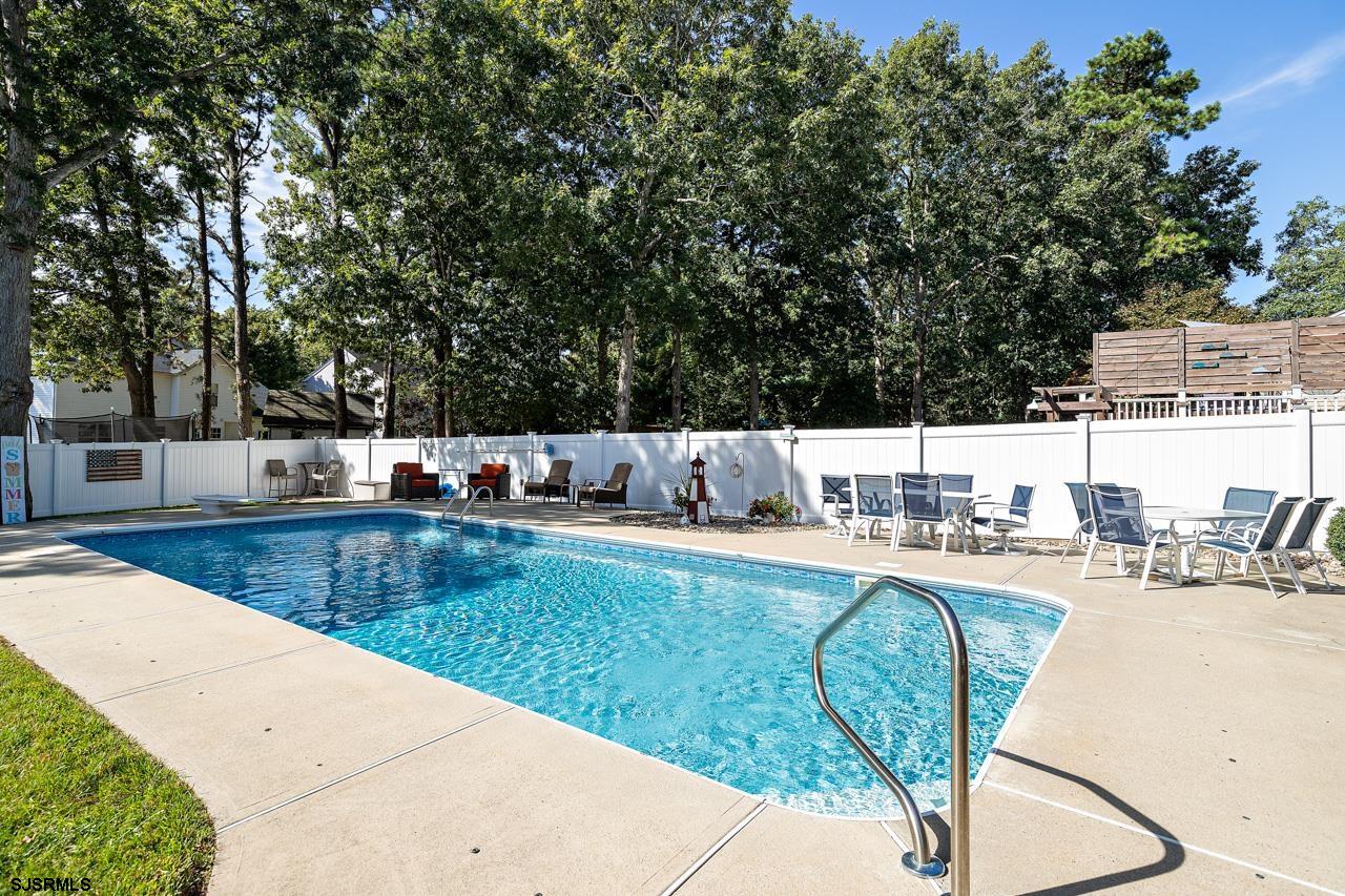 203 Torpedo Road Manahawkin, NJ 08050 - Photo 9 of 48 a view of a swimming pool with a lounge chair
