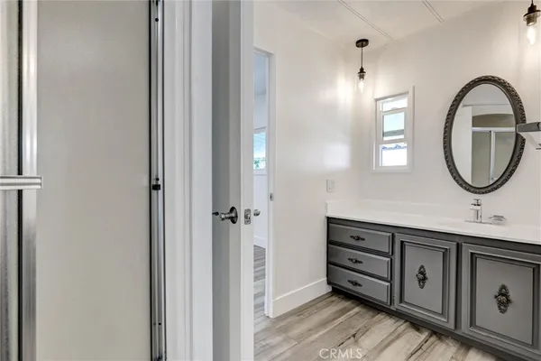 an empty room with a hardwood and stairs