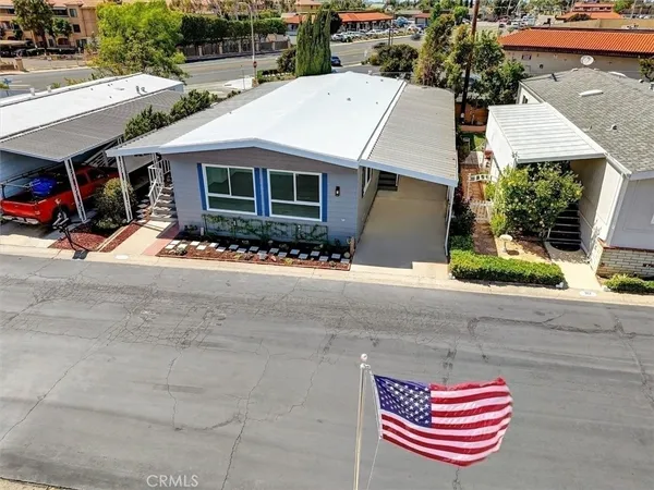 an aerial view of a residential houses with outdoor space and street view