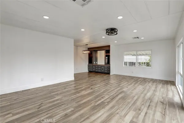 a view of a center island and chandelier in a room