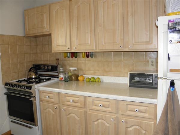 88 Hardy Pond Road Waltham, MA 02451 - Photo 11 of 29 a kitchen with granite countertop white cabinets and white appliances