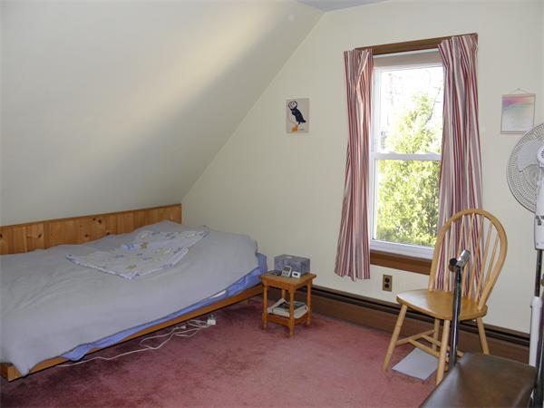 88 Hardy Pond Road Waltham, MA 02451 - Photo 18 of 29 a bedroom with a window and a chair