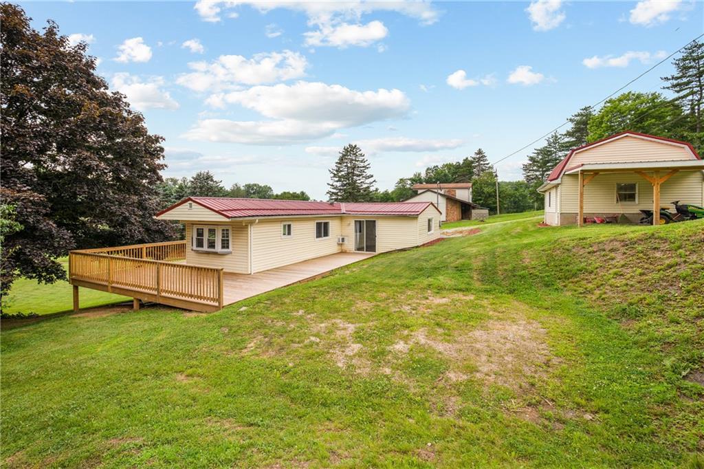 189 Anna Beth Road Acme, PA 15610 - Photo 3 of 32 a white house with a big yard and large trees