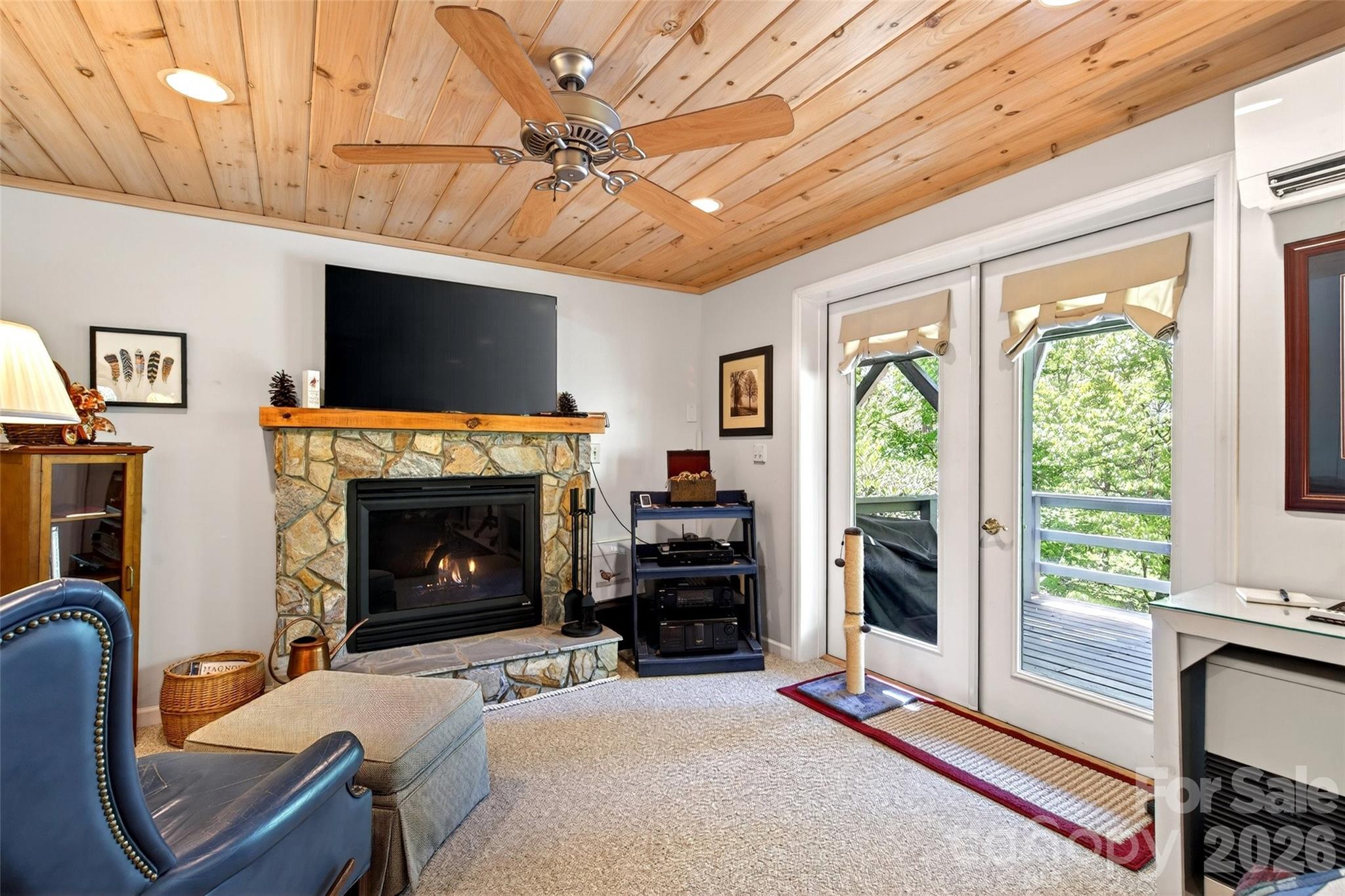 334 Harbor Lake Road Newland, NC 28657 - Photo 26 of 48 a living room with furniture a flat screen tv and a fireplace