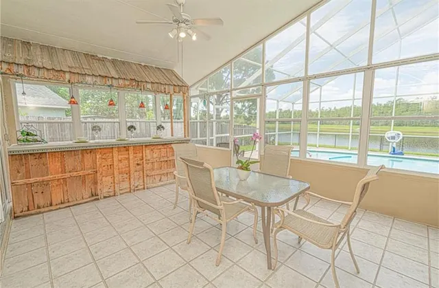 a dining room with furniture a chandelier and wooden floor