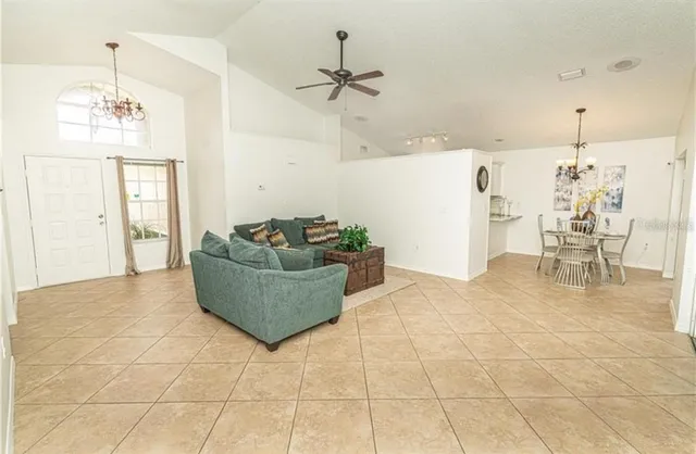 a living room with couches and kitchen view