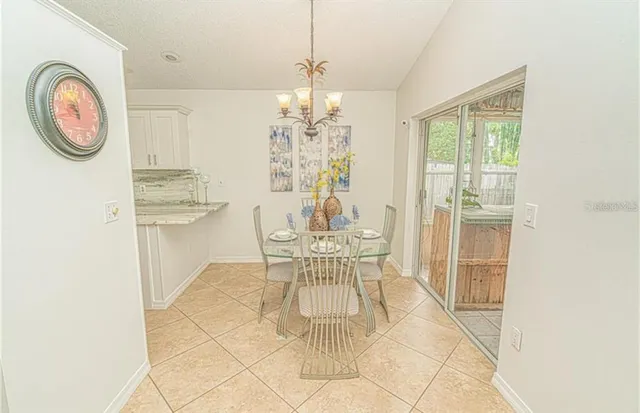 a dining room with furniture a chandelier and a rug