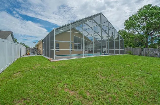 a view of a backyard with a cabin and wooden fence