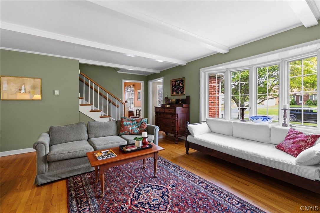 410 Meadow Road Geddes, NY 13219 - Photo 4 of 50 The formal living room has beautiful beams, moldings fireplace and large window overlooking the front yard.