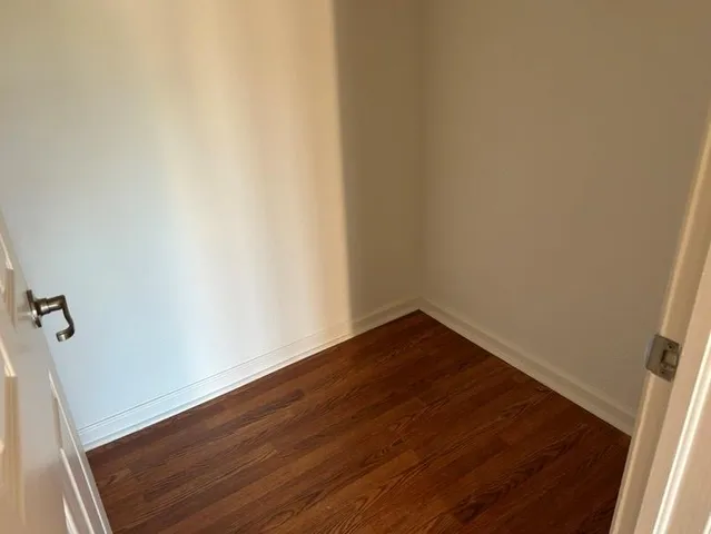 a view of a small space with wooden floor and a sink