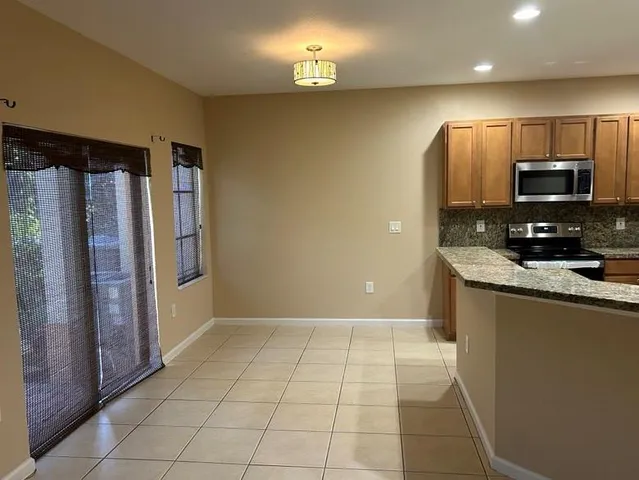 a view of a kitchen with a sink and a refrigerator