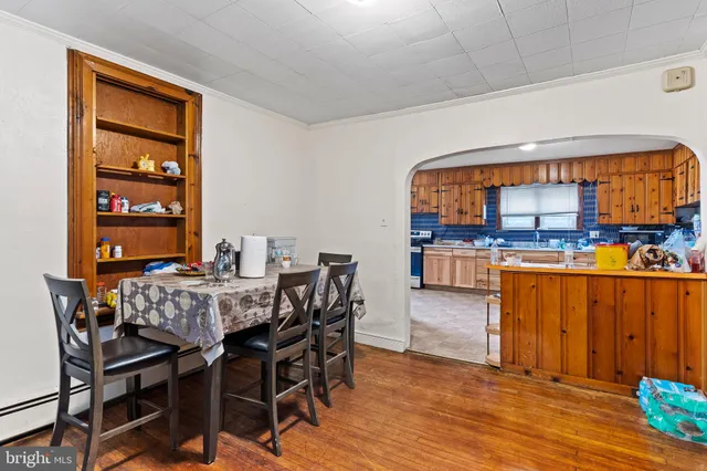 a view of a dining room kitchen with furniture and wooden floor