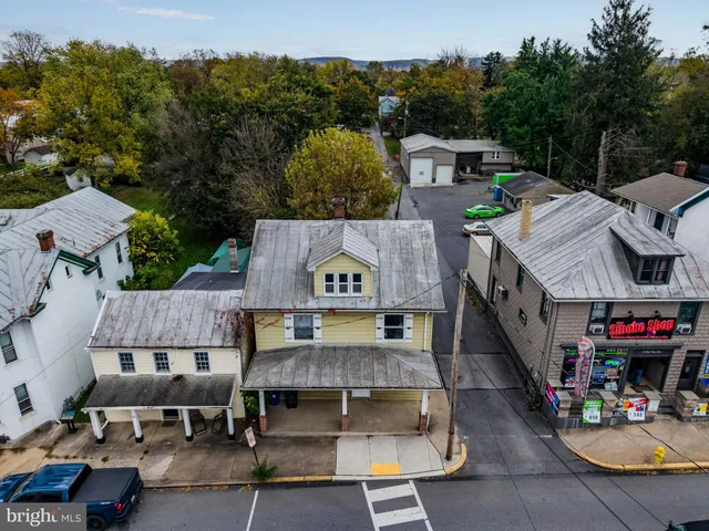 an aerial view of multiple houses with a yard