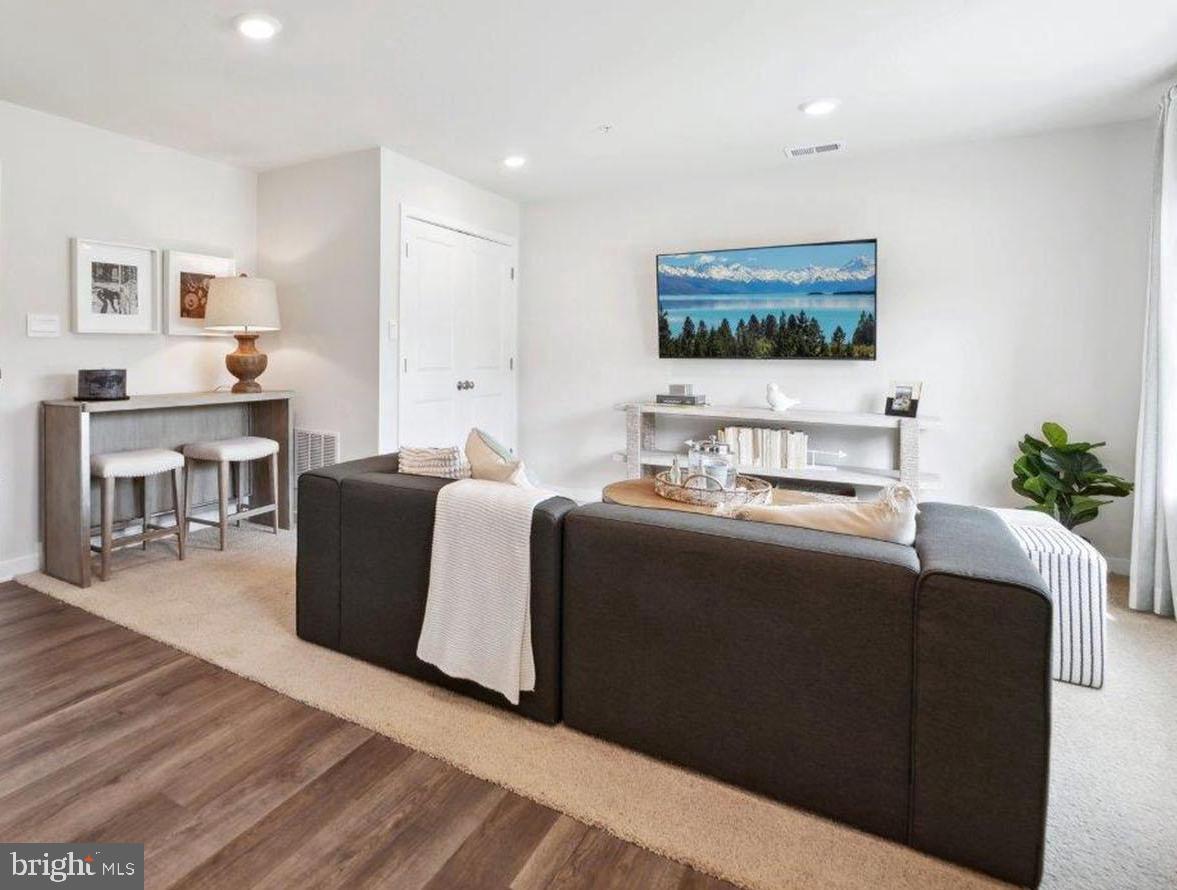 23 Clementon Road East Gibbsboro, NJ 08026 - Photo 12 of 40 a living room with furniture a wooden floor and a large window
