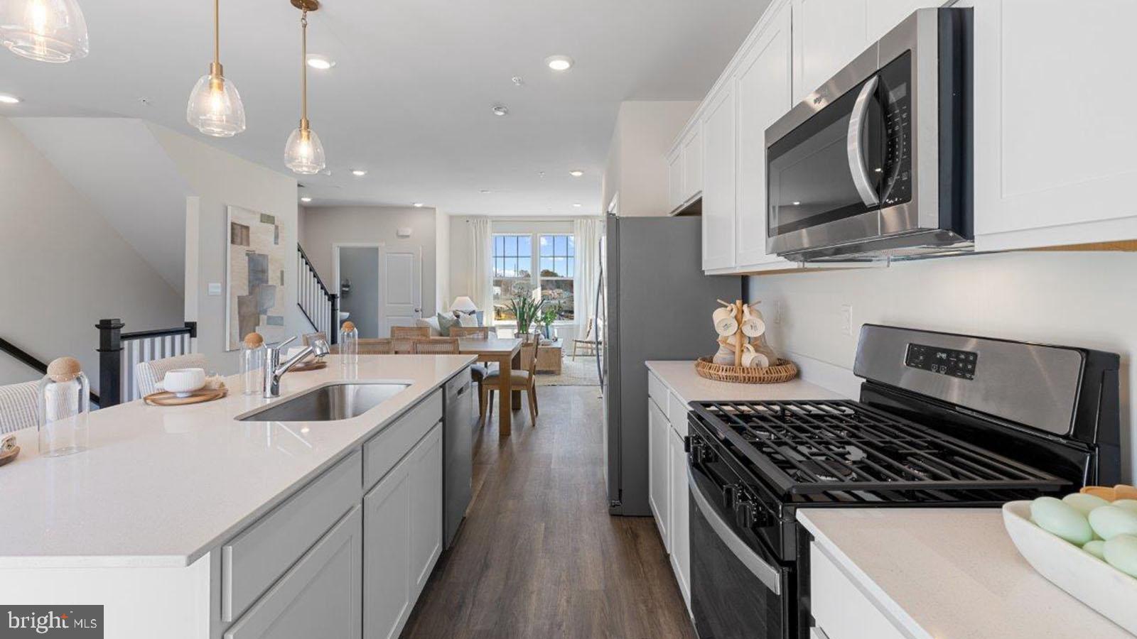 23 Clementon Road East Gibbsboro, NJ 08026 - Photo 21 of 40 a kitchen with kitchen island granite countertop a sink a stove oven and cabinets