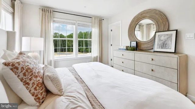 a spacious bedroom with a bed and a large window