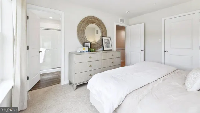 a bedroom with a bed and a dresser