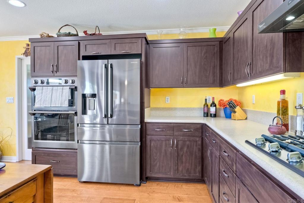 345 La Soledad Way Oceanside, CA 92057 - Photo 11 of 34 a kitchen with refrigerator and cabinets