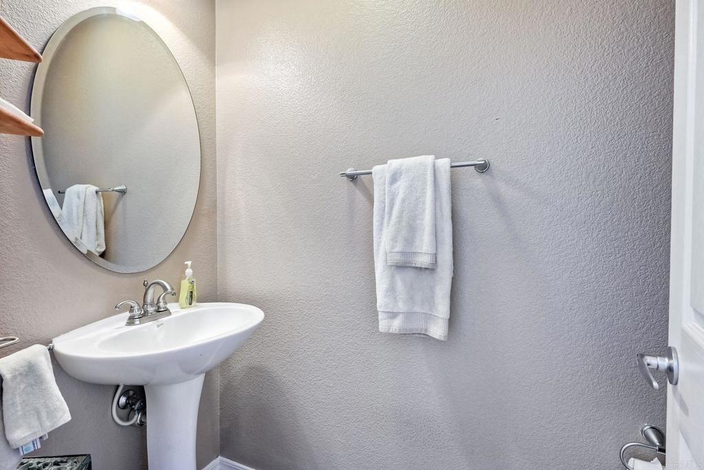 345 La Soledad Way Oceanside, CA 92057 - Photo 13 of 34 a bathroom with a sink and mirror