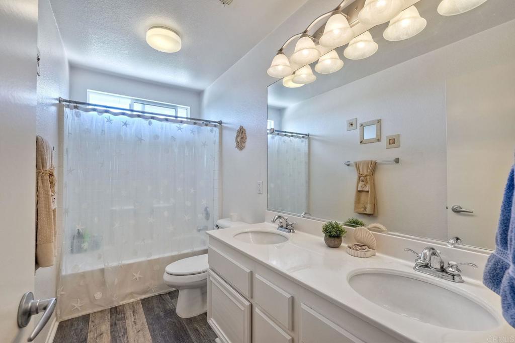 345 La Soledad Way Oceanside, CA 92057 - Photo 14 of 34 a bathroom with a double vanity sink toilet and shower