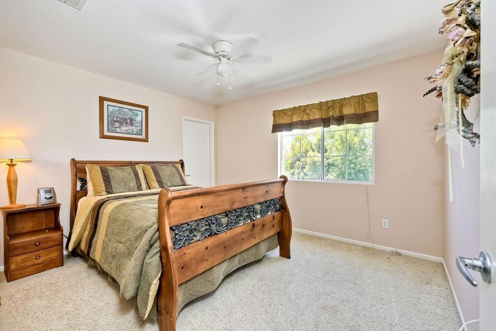 345 La Soledad Way Oceanside, CA 92057 - Photo 16 of 34 a bed sitting in a bedroom next to a window