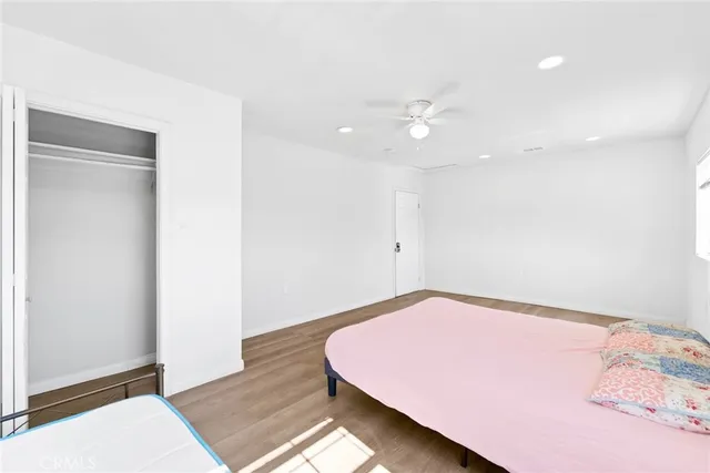 a bedroom with a bed and a ceiling fan