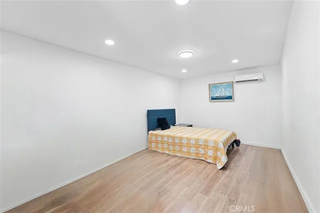 a bedroom with a bed and a mirror