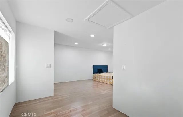 a view of a room with wooden floor and electronic appliances