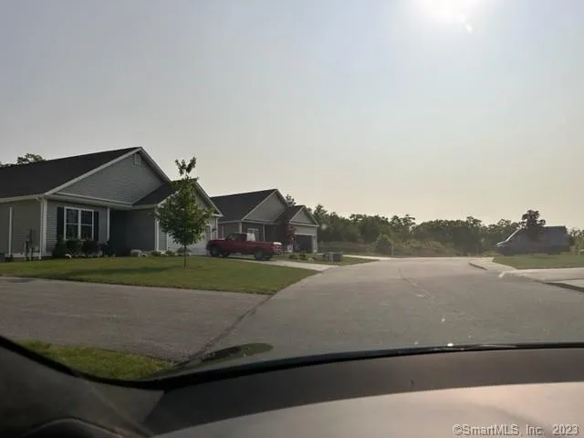 a view of houses with outside space and lake view