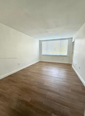a view of an empty room and wooden floor