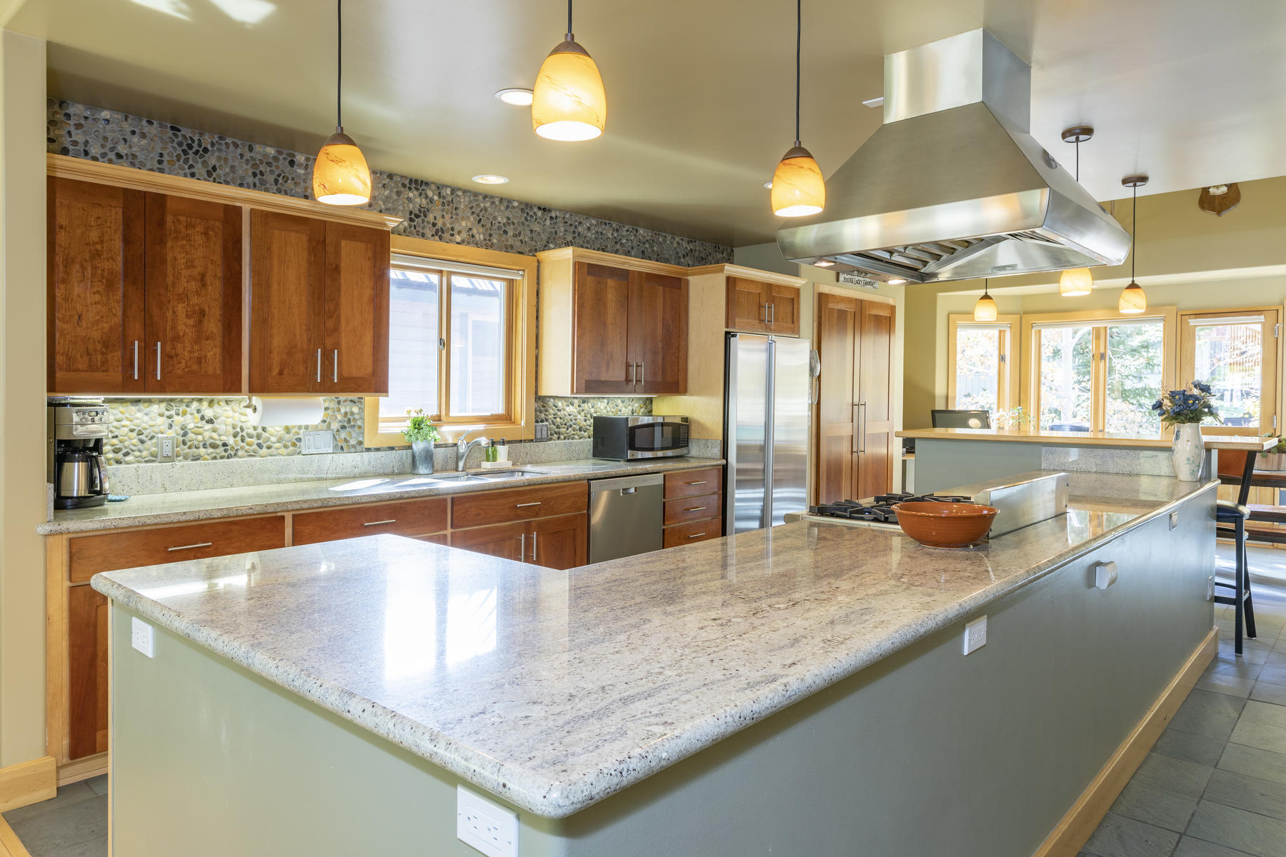 784 Smuggler Avenue, Unit 2 Telluride, CO 81435 - Photo 5 of 8 a kitchen with stainless steel appliances granite countertop a sink a stove and a wooden floors