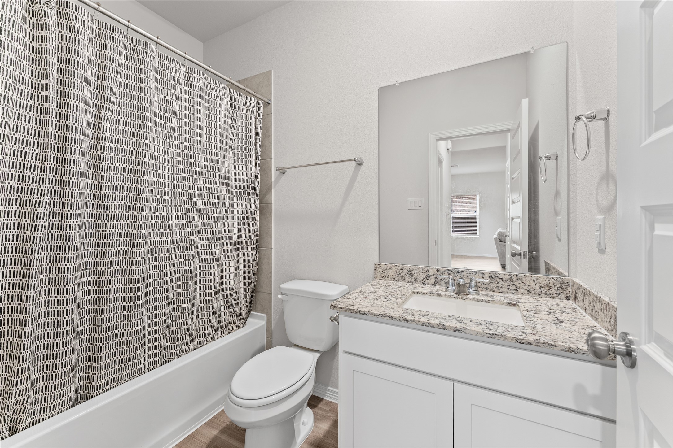 23326 Spring Genesis Lane Katy, TX 77493 - Photo 24 of 32 a bathroom with a granite countertop toilet a sink and a mirror