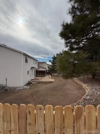 a view of yard with swimming pool and trees